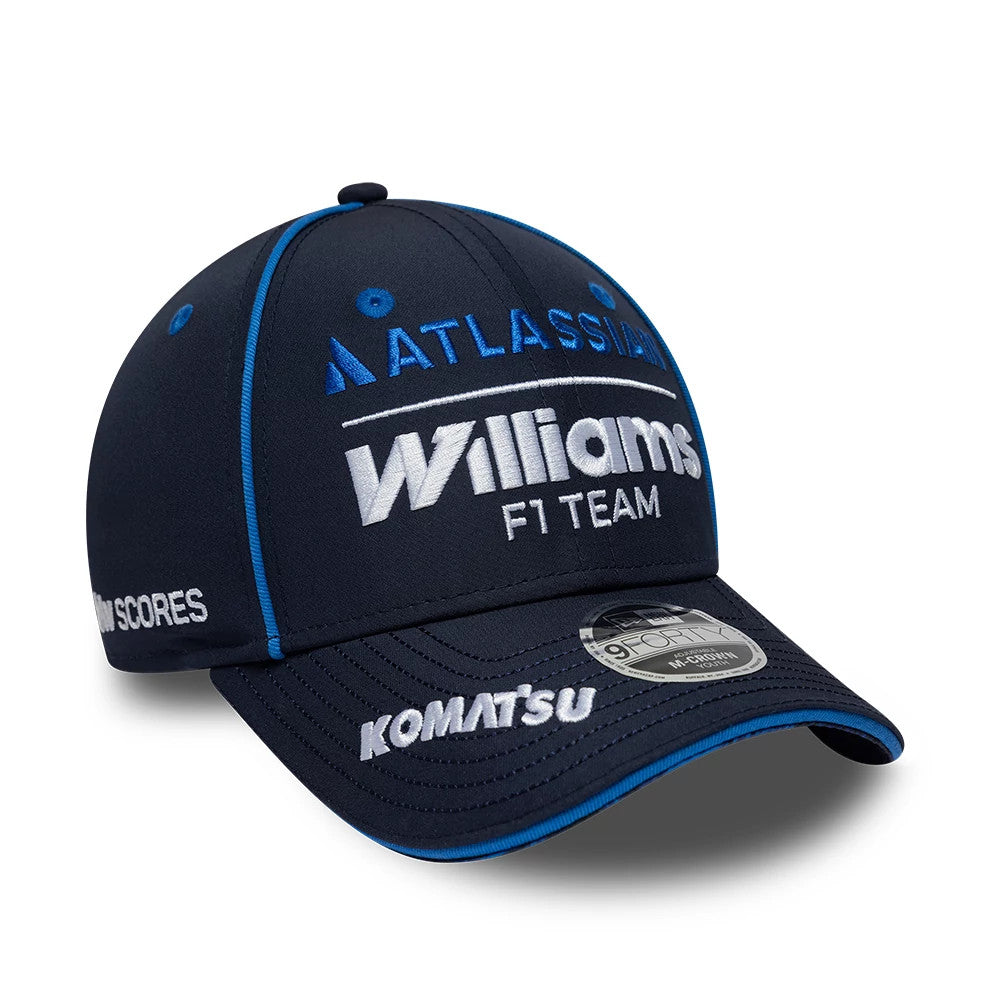 Youth Williams Team Navy New Era 9FORTY M-Crown Adjustable Cap, three-quarter view showing white embroidered Williams F1 Team lettering on the front panel, blue accents on top button and eyelets, and the 9FORTY size sticker on the navy curved visor.