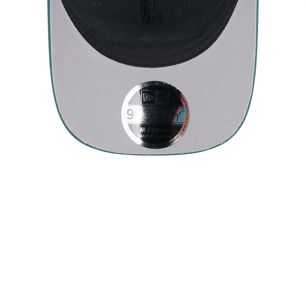 Eagles NFL All Over Dark Green New Era 9FORTY M-Crown A-Frame Trucker Adjustable Cap, inside view showing a light grey undervisor with a 9FORTY size sticker, bordered by a dark green edge and a contrast black sweatband.