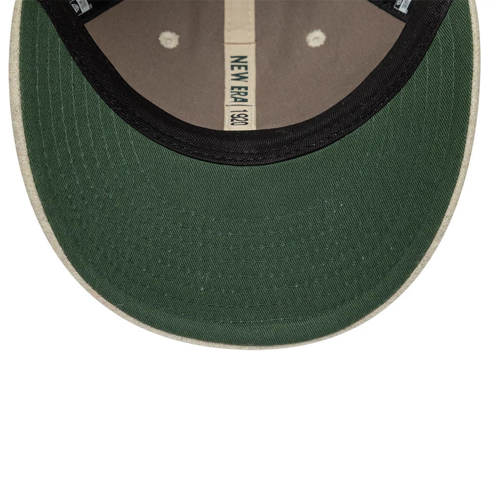 New Era Heritage Cream Retro Crown 9FIFTY Adjustable Cap, inside view showing a black sweatband, tan taping with the New Era logo centred, and a green undervisor with stitching and two interior eyelets.
