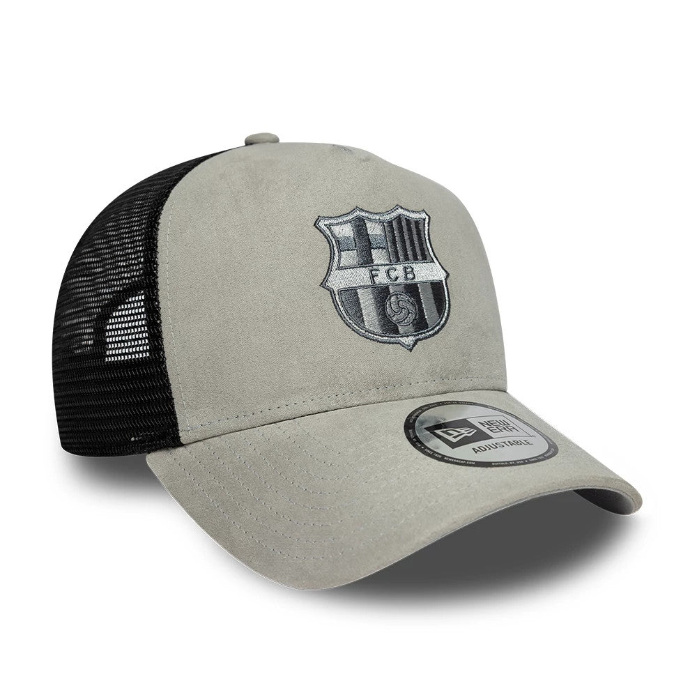 FC Barcelona Faux Suede Grey New Era 9FORTY A-Frame Trucker Adjustable Cap, three-quarter view showing the black and grey embroidered FCB shield logo on the front panel, with a grey curved visor and a New Era 9FORTY size sticker.