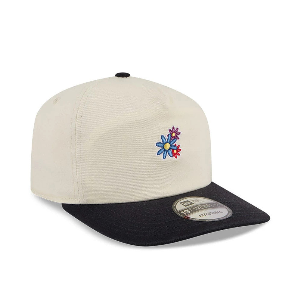 New Era Daisies Cream New Era 19TWENTY Adjustable Cap, three-quarter view showing colourful embroidered daisy flowers on the front panel, a contrasting black visor, and a 19TWENTY size sticker on the visor.