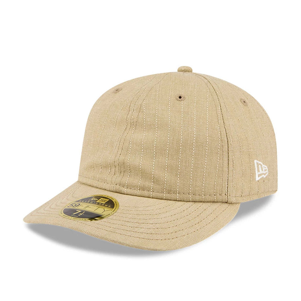 New Era Herringbone Beige Retro Crown 59FIFTY Fitted Cap, three-quarter view showing the white embroidered New Era flag logo on the left side, a curved beige visor with gold 59FIFTY size sticker, and herringbone pattern on the crown.