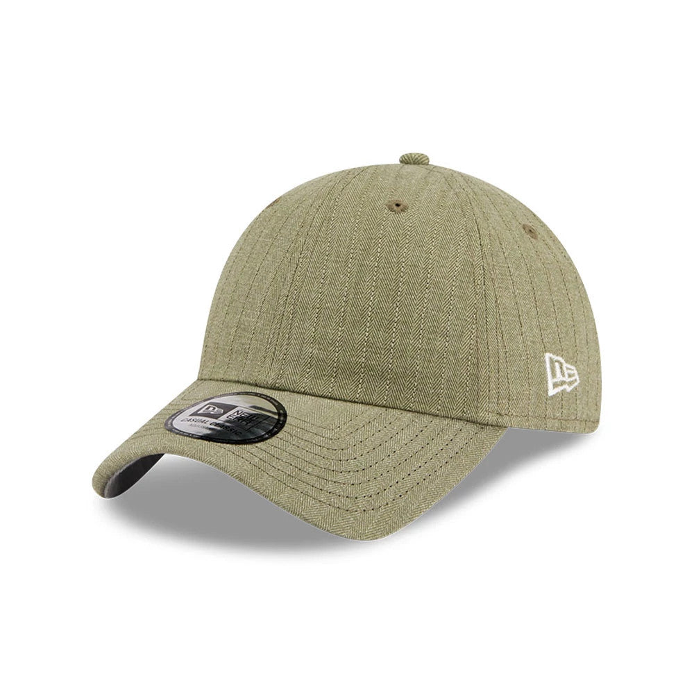 New Era Herringbone Pinstripe Green Casual Classic Adjustable Cap, three-quarter view showing the white New Era flag logo embroidered on the left side, herringbone pinstripe pattern on green fabric, and Classic 9FORTY size sticker on the visor.