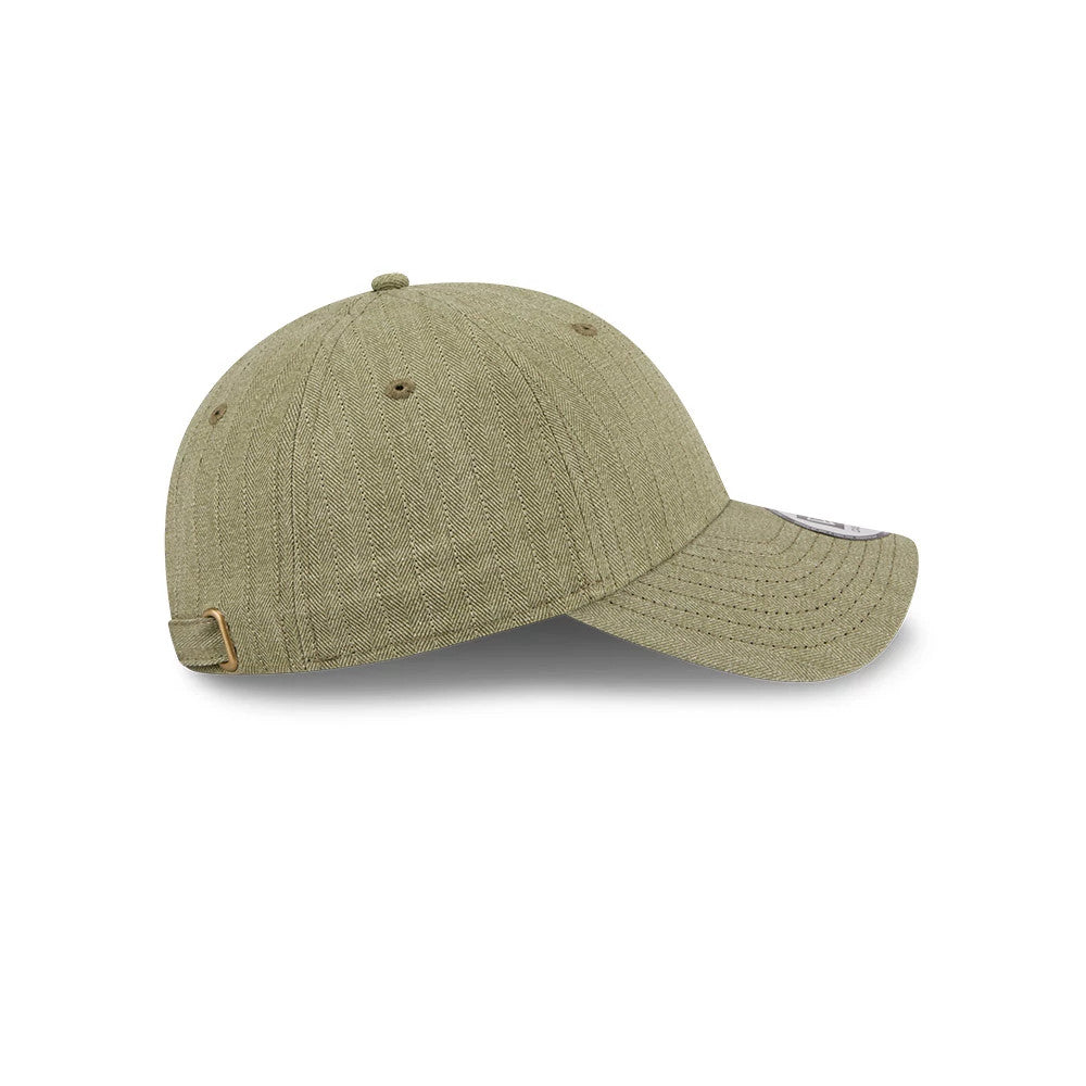 New Era Herringbone Pinstripe Green Casual Classic Adjustable Cap, side view showing the herringbone texture on the olive green panels, a curved visor with pinstripes, and a gold buckle on the adjustable strap.