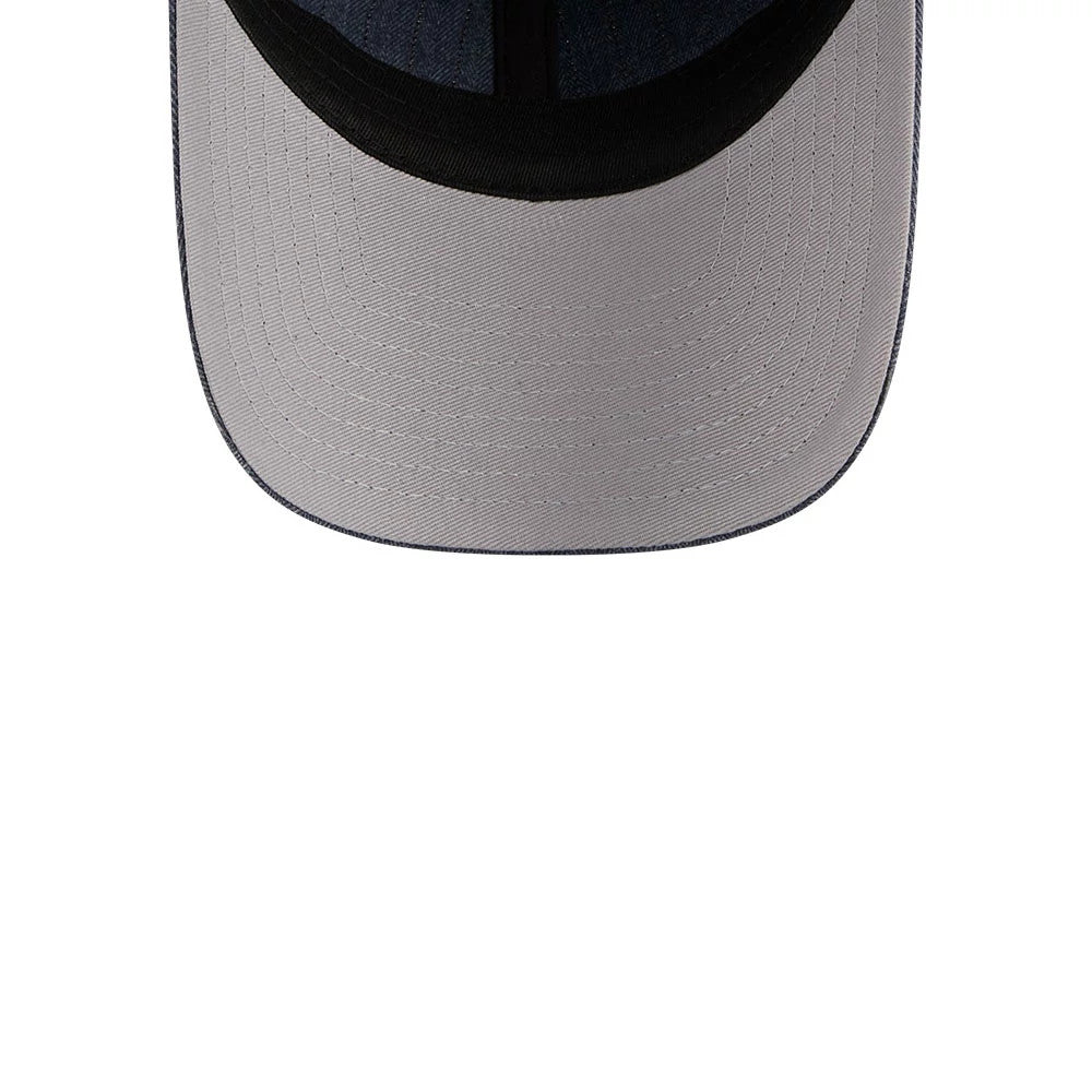New Era Herringbone Pinstripe Navy Casual Classic Adjustable Cap, inside view showing the grey undervisor, black internal sweatband, and dark taping that lines the panels, creating a neat contrast against the herringbone texture.