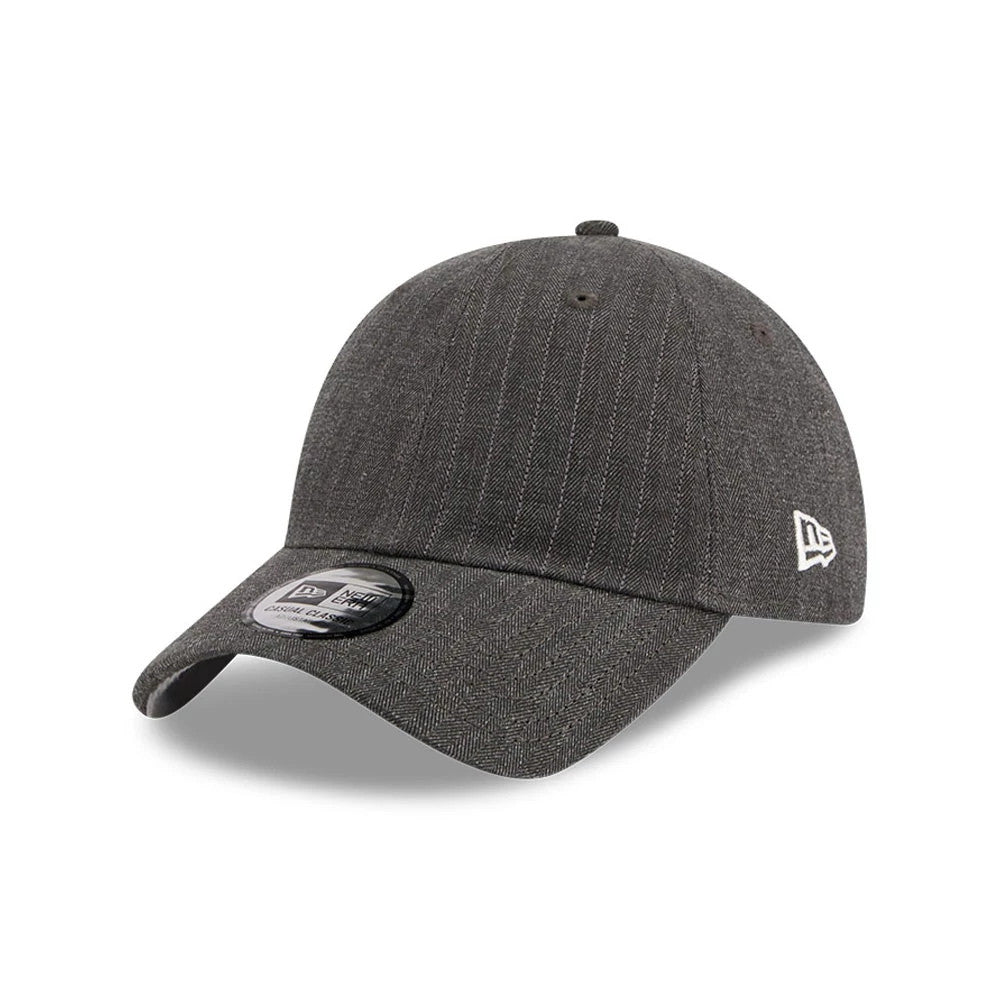 New Era Herringbone Pinstripe Charcoal Casual Classic Adjustable Cap, three-quarter view showing a black pre-curved visor with a size sticker, prominent herringbone pinstripe pattern on the structured crown.