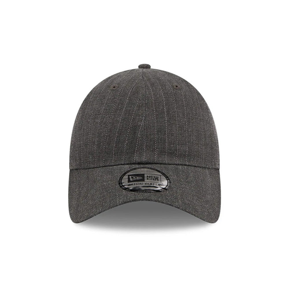 New Era Herringbone Pinstripe Charcoal Casual Classic Adjustable Cap, front view showing a curved visor with a New Era Casual Classic sticker, detailed herringbone pinstripe pattern on the structured crown, and embroidered eyelets.
