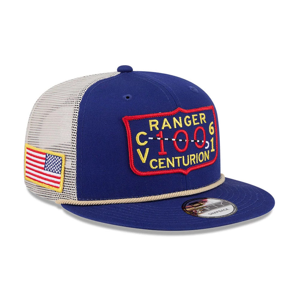 Top Gun Dark Blue New Era 9FIFTY Trucker Adjustable Cap, three-quarter view showing the red and yellow embroidered Ranger Centurion patch on the front panel, a beige mesh back, and an American flag patch on the left side.