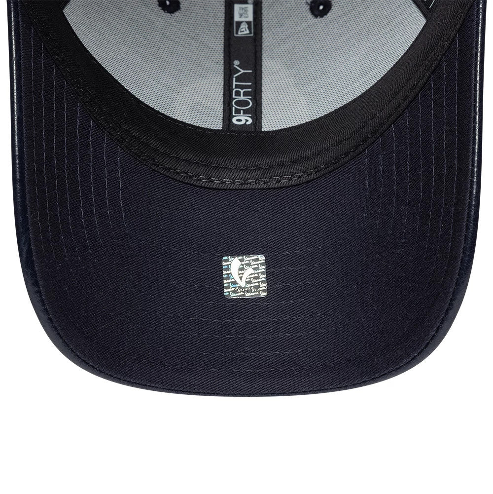 Vespa Crinkle PU Navy New Era 9FORTY Adjustable Cap, inside view showing grey sweatband with black taping featuring the 9FORTY logo, a silver holographic sticker on the navy undervisor, and black stitching lines along the visor curve.