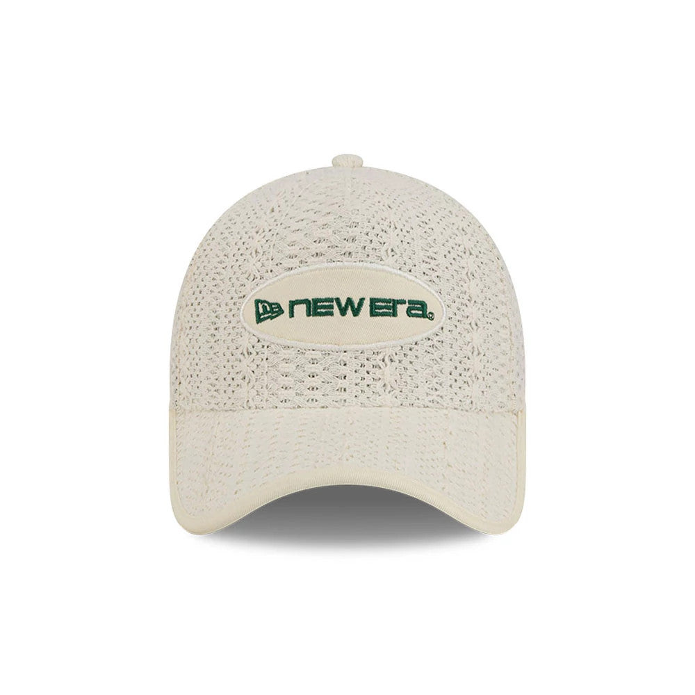New Era Oval Patch Cream 59FORTY A-Frame Fitted Cap, front view showing the cream textured crown with an oval patch featuring green New Era logo embroidery, complemented by a matching cream curved visor.
