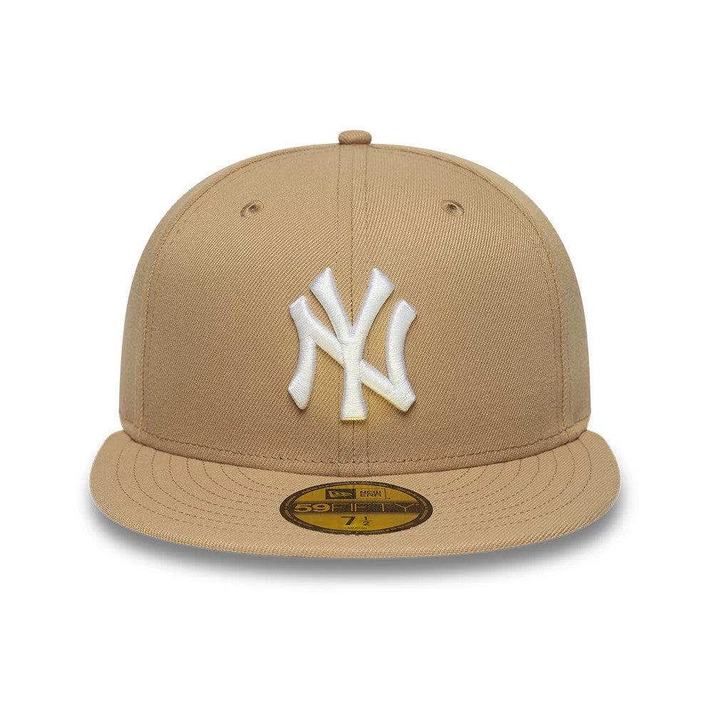 New York Yankees MLB League Essential Light Beige New Era 59FIFTY Fitted Cap, front view showing the white raised embroidered NY logo on the front panel, with a matching beige flat visor and a gold 59FIFTY size sticker on the visor.