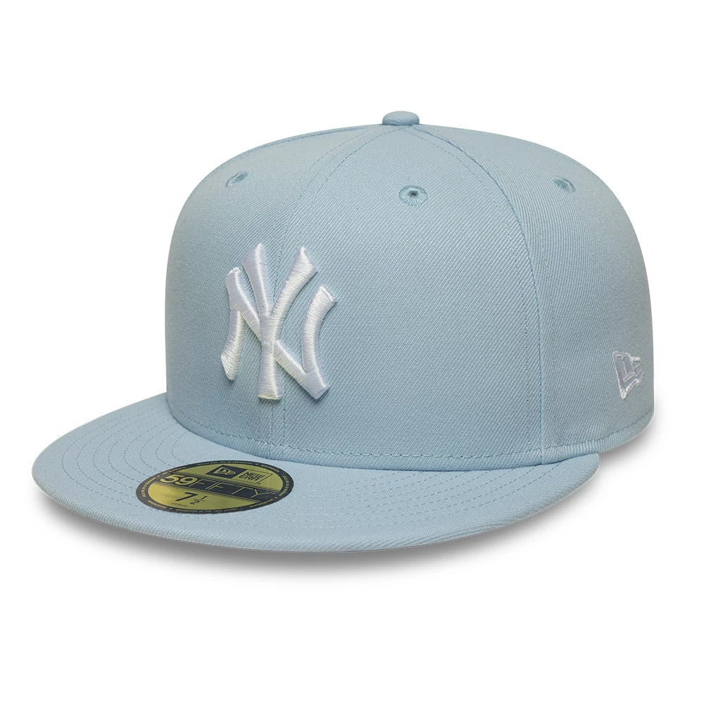 New York Yankees MLB League Essential Pastel Blue New Era 59FIFTY Fitted Cap, three-quarter view showing a white raised embroidered NY logo on the front panel, pastel blue flat visor with gold 59FIFTY size sticker.