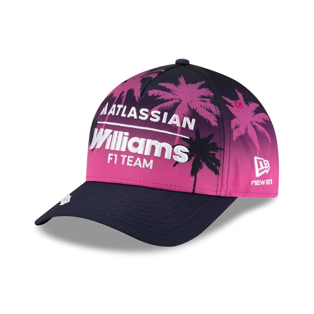 Williams Miami Navy New Era 9FORTY M-Crown A-Frame Adjustable Cap, three-quarter view showing the embroidered white Williams F1 Team logo on a pink gradient front with palm tree graphics, navy curved visor, and New Era flag logo on the left side.