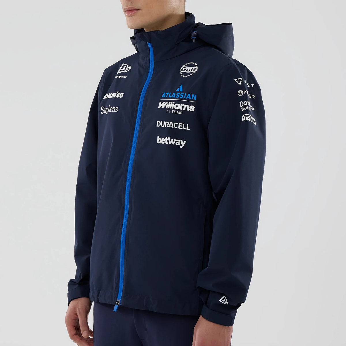 New Era Williams Navy Rain Jacket, three-quarter view on-model featuring a light blue zip running vertically down the front, multiple white logos printed on the chest and sleeves, and a raised New Era logo on the lower left sleeve.