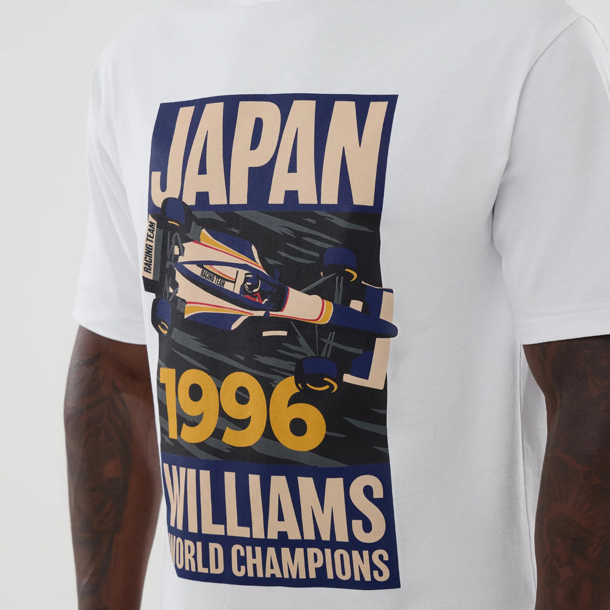 New Era Williams Japan 1996 White Oversized T-Shirt, front view showcasing a graphic with the word JAPAN at the top, a detailed race car illustration in the centre, and 1996 WILLIAMS WORLD CHAMPIONS text prominently at the bottom.