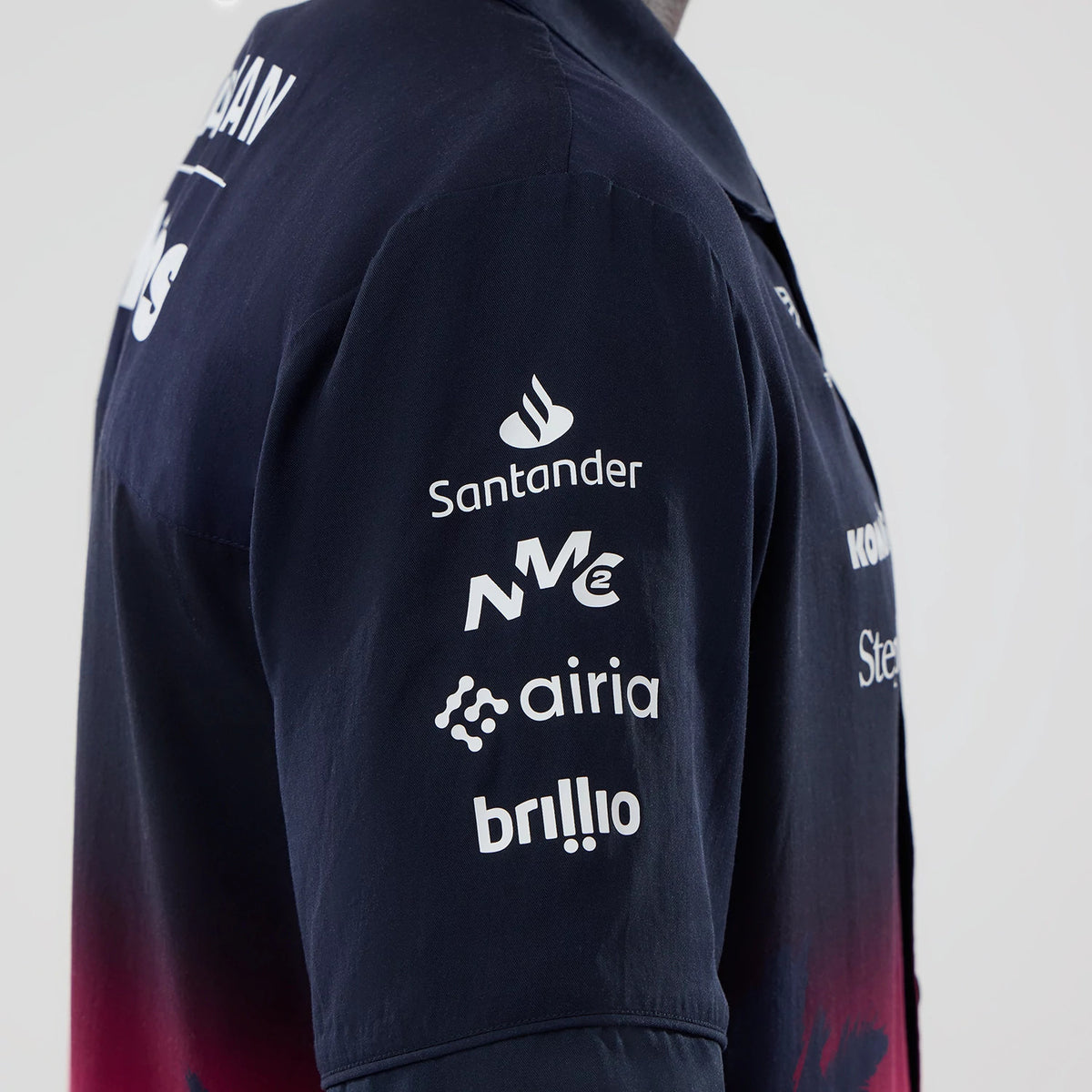 New Era Williams Miami Navy Short Sleeve Shirt, side view showing multiple sponsor logos including Santander, NWC, and Airia on the right sleeve, with a gradient design from navy to red on the main body.