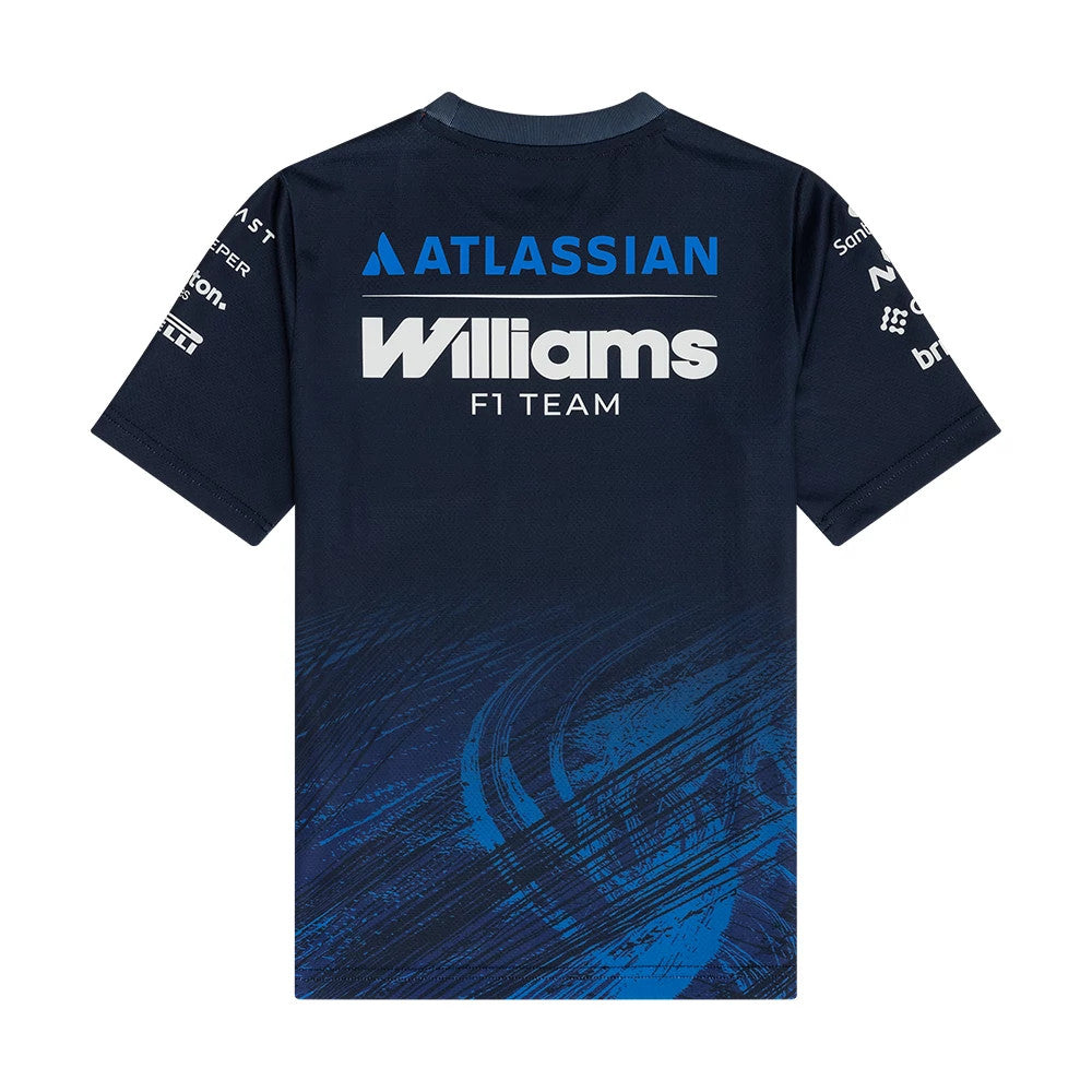 New Era Williams Youth Navy Tech T-shirt, back view displaying the white Williams F1 Team lettering, Atlassian logo above it, and additional sponsor logos on the sleeves, all set against a navy backdrop with dynamic blue graphic accents.