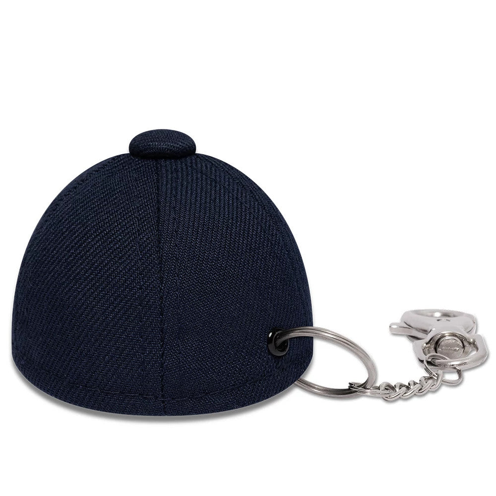 New Era Williams Navy Cap Key Chain, rear view showing a small navy cap design with a rounded top button, detailed stitching along the panels, and a silver keyring attached through a eyelet on one side.