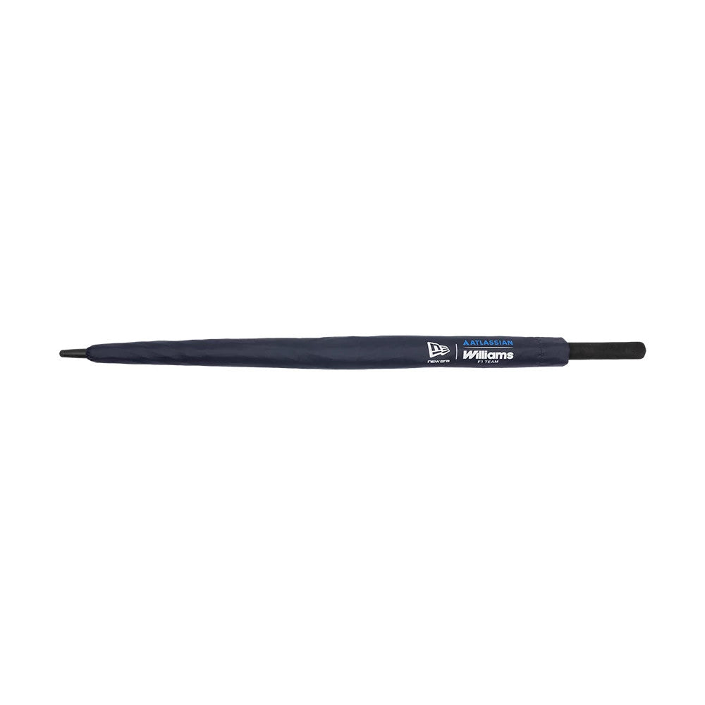 New Era Williams Team Navy Umbrella, side view showing the closed navy canopy with New Era and Williams Racing branding in white and blue near the velcro strap, along with a black handle at the base.