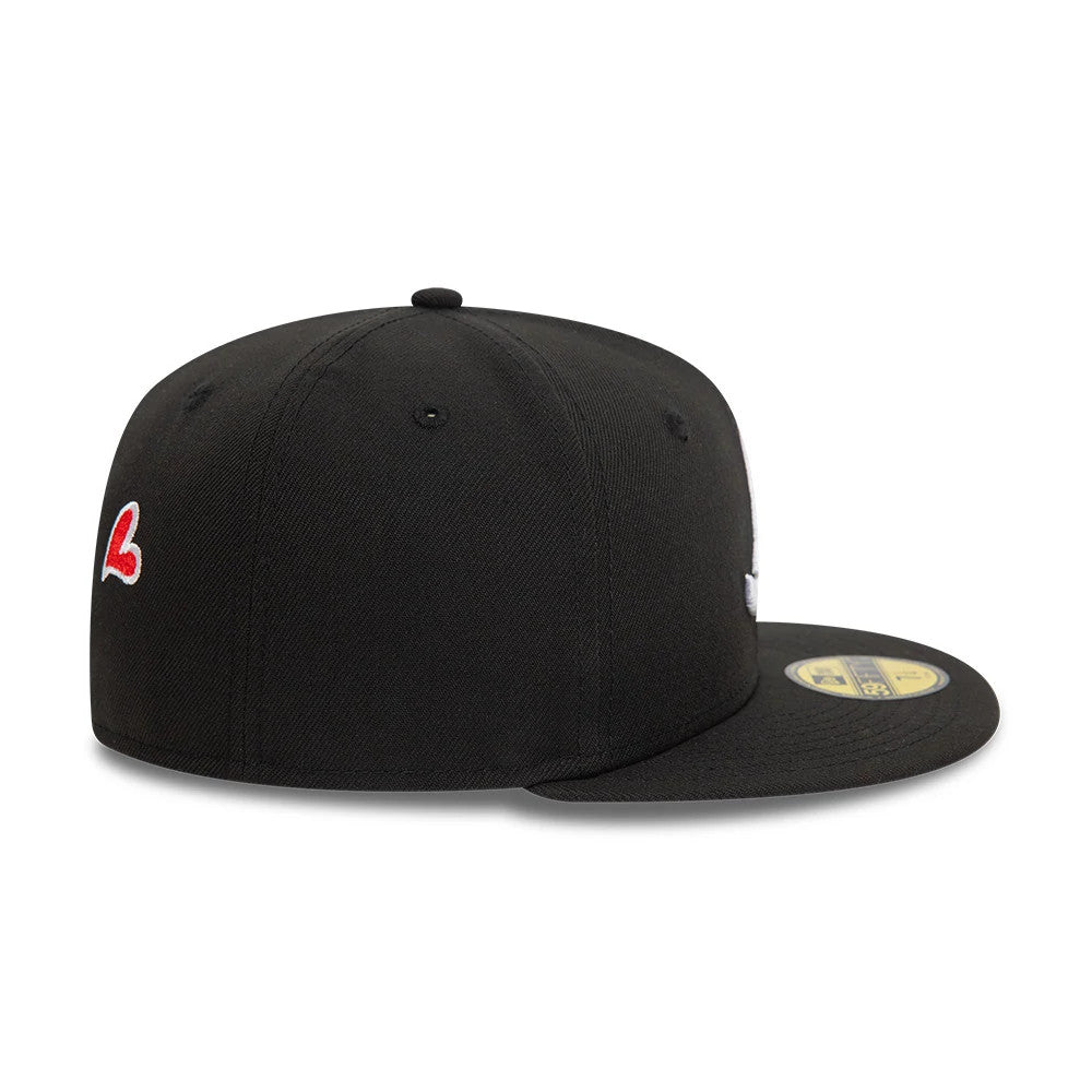 Atlanta Braves MLB Heart Icon Black New Era 59FIFTY Fitted Cap, side view showing the red embroidered heart icon on the side panel, the structured black crown with matching eyelets and top button, and the gold 59FIFTY size sticker on the flat visor.