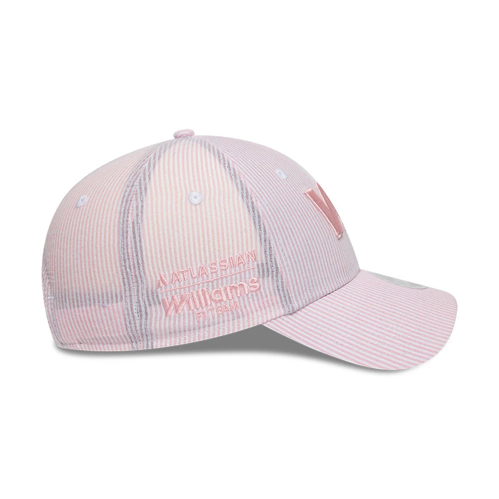 Williams Womens Seersucker Pastel Pink New Era 9FORTY Adjustable Cap, side view showing the embroidered Williams logo in pastel pink on the left panel, white eyelets on the striped crown, and a curved pink visor.