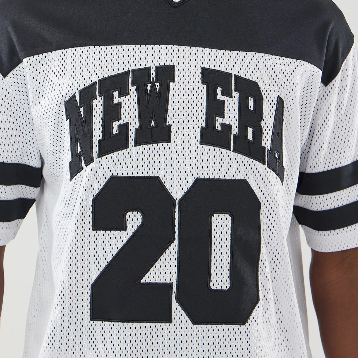 New Era Mesh White Oversized T-Shirt, front view showing black New Era lettering across the chest and the number 20 below, detailed with black horizontal stripes on the short sleeves and a contrasting black shoulder yoke.