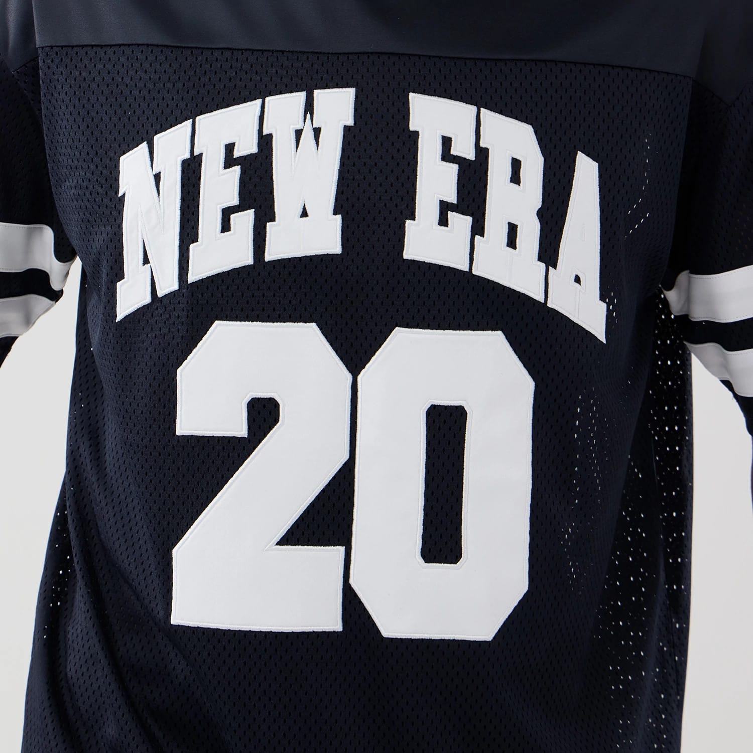 The model is wearing this New Era Mesh Oversized T-Shirt in navy. 4