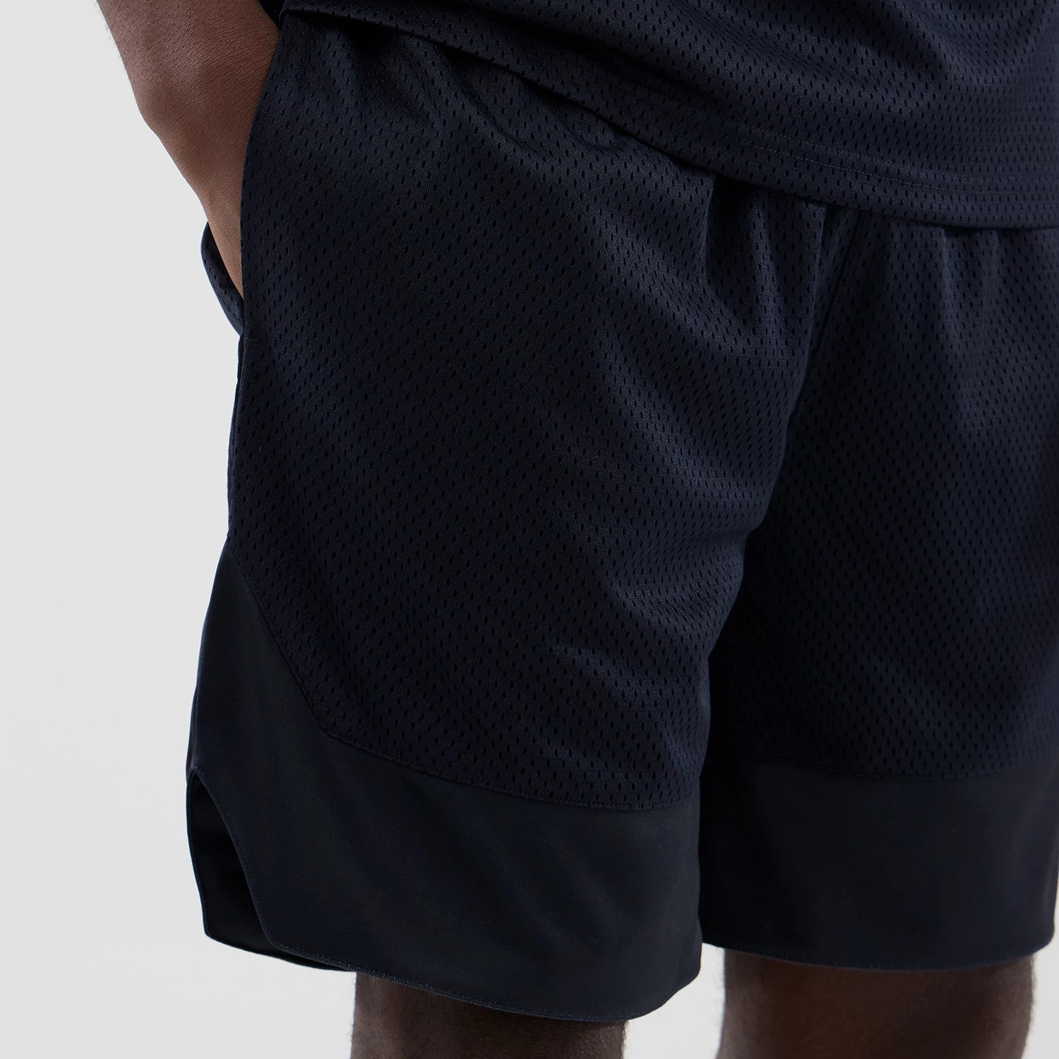 The model is wearing this New Era Mesh Oversized Shorts in navy. 3