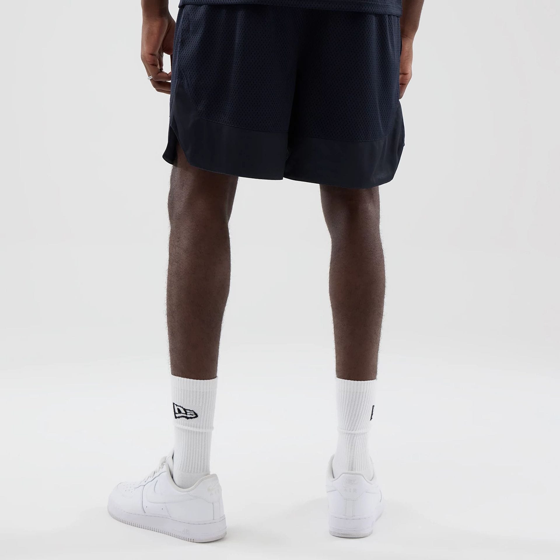 The model is wearing this New Era Mesh Oversized Shorts in navy. 2