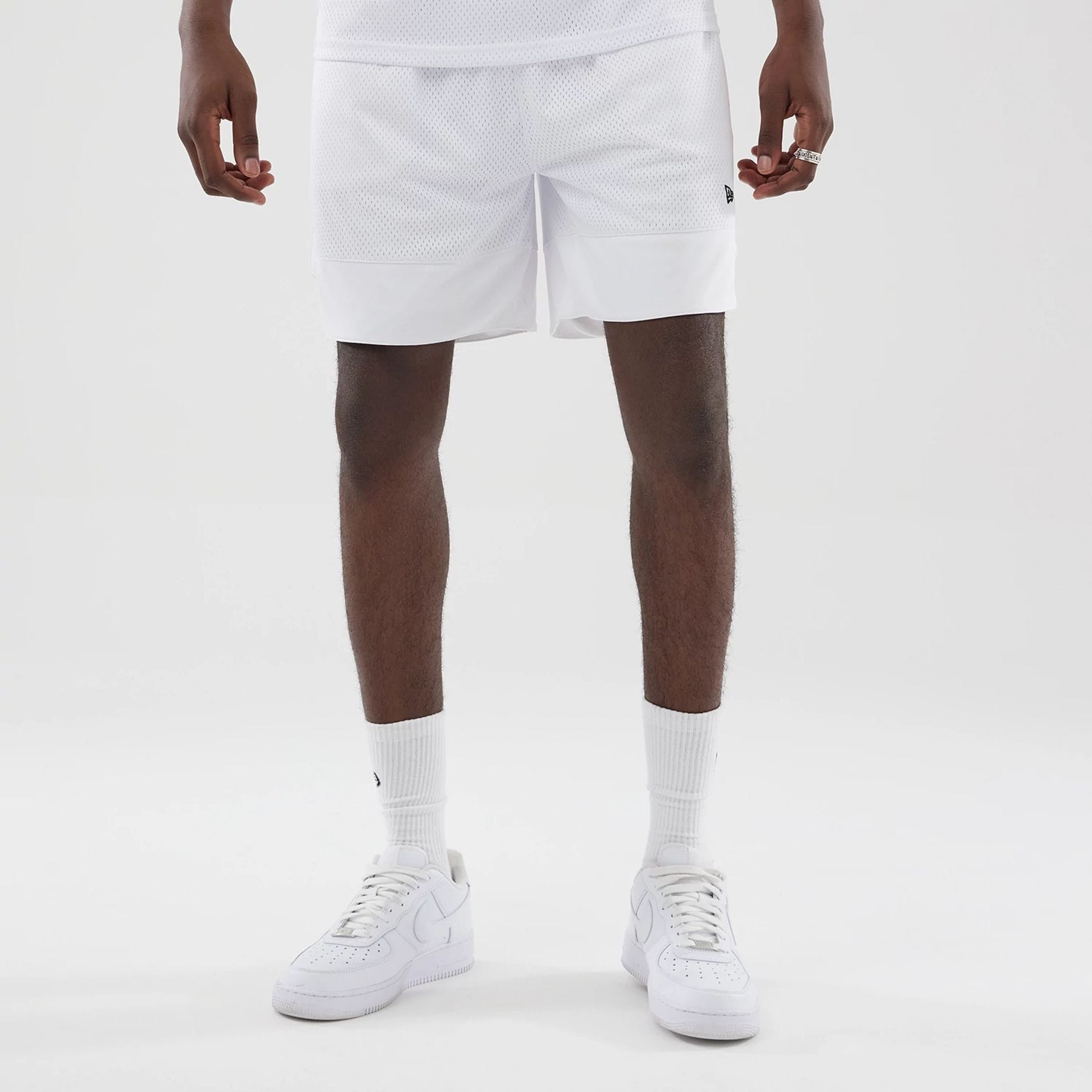 The model is wearing this New Era Mesh Oversized Shorts in white. 1