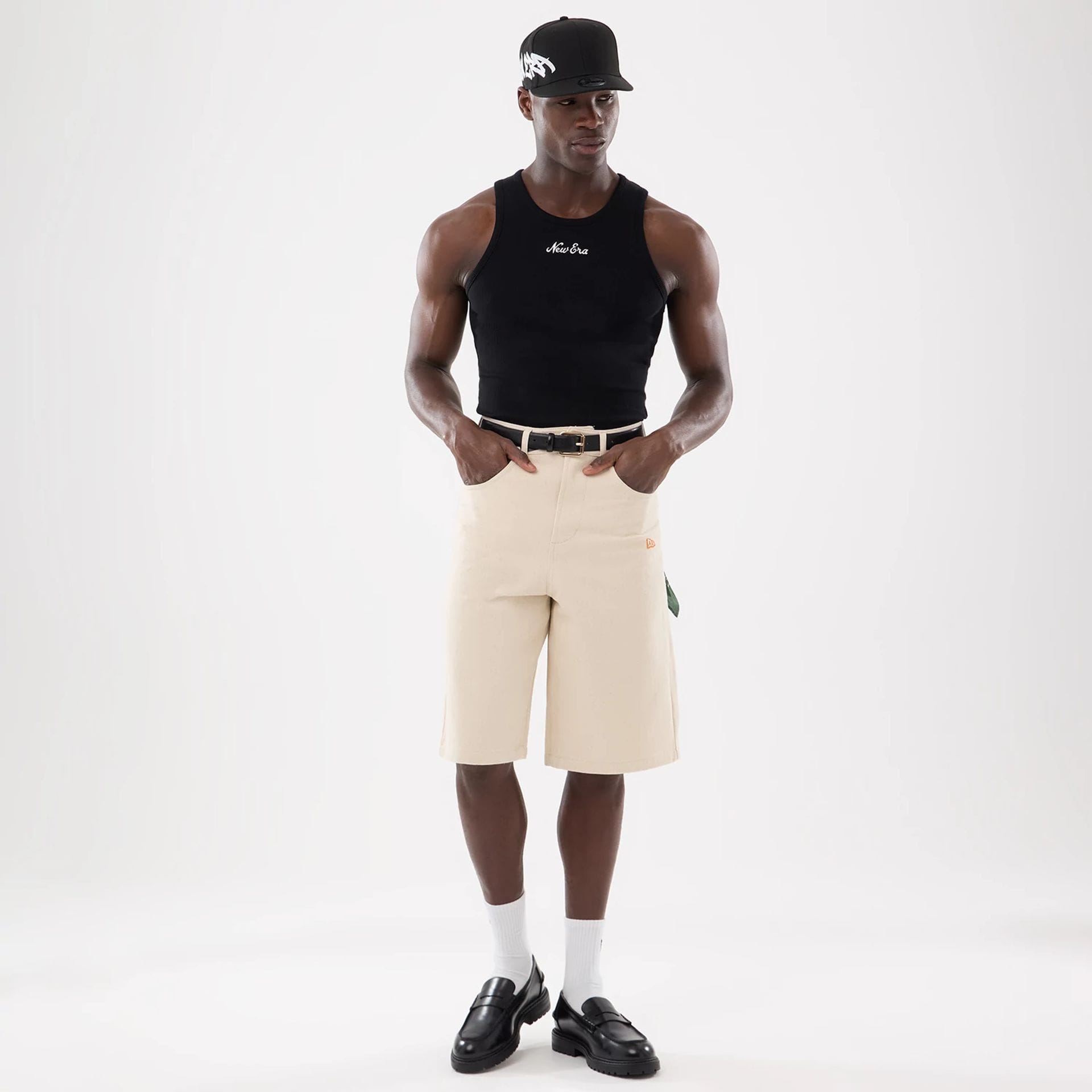 The model is wearing this New Era Rib Vest in black. 8