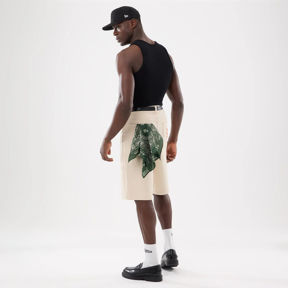 The model is wearing this New Era Rib Vest in black. 12