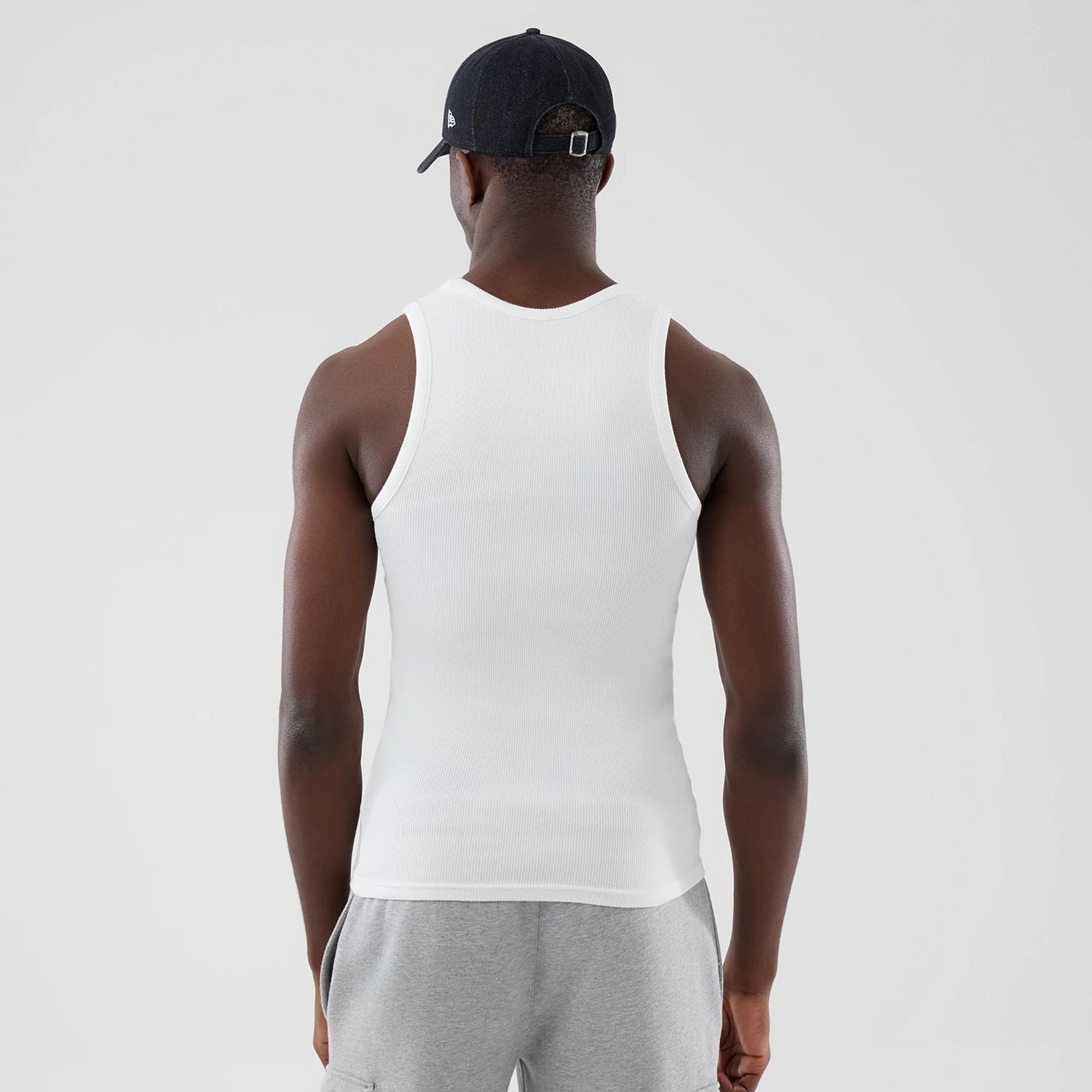 The model is wearing this New Era Rib Vest in white. 2