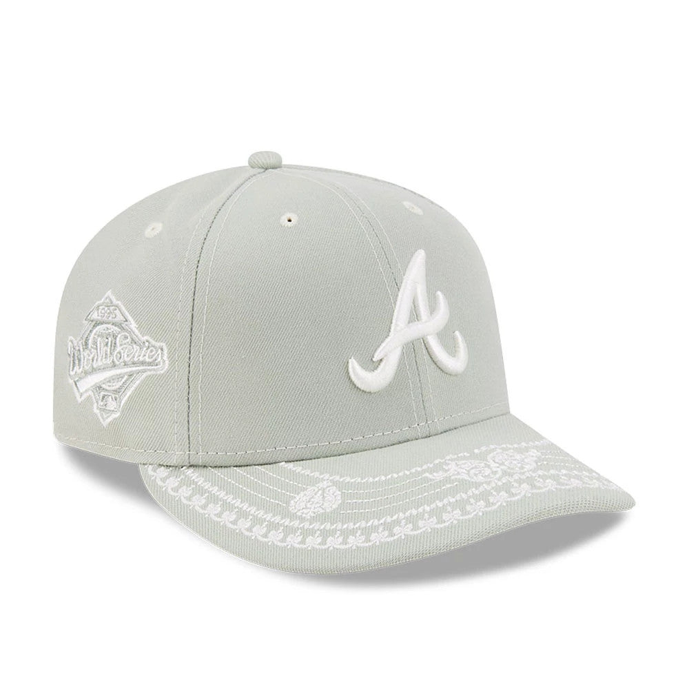 Atlanta Braves MLB Pastel Green New Era 59FIFTY Fitted Cap, three-quarter view showing the raised white embroidered Atlanta Braves logo on the front panel, intricate white embroidery across the visor, and a 1995 World Series patch on the right side.