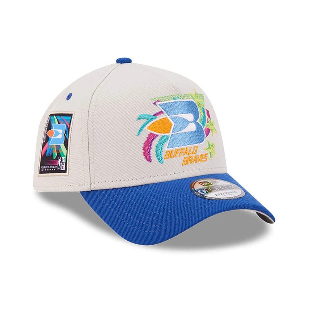Pictured is this NBA Hardwood Classic Buffalo Braves 9FORTY A-Frame Adjustable cap in light beige & blue. 1
