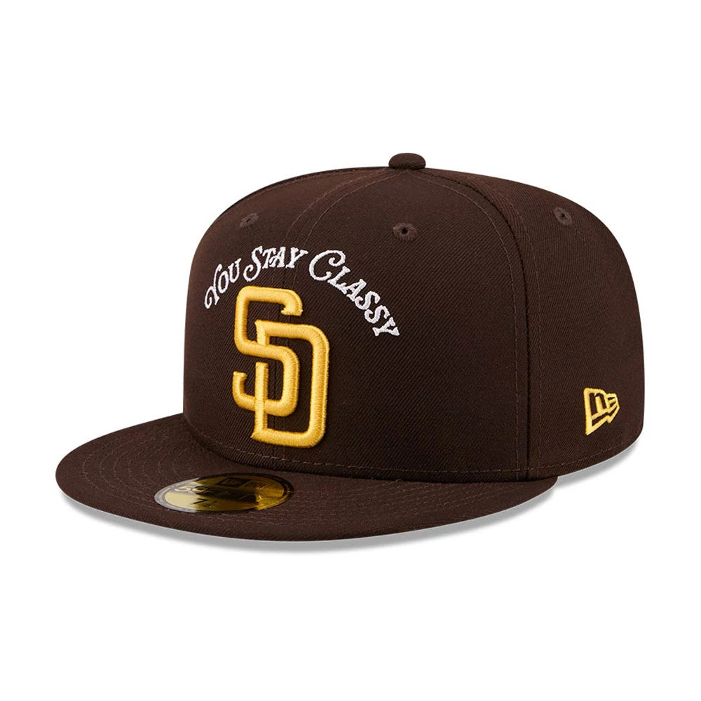 San Diego Padres MLB X Anchorman Stay Classy Black New Era 59FIFTY Fitted Cap, front view featuring raised gold SD emblem with white You Stay Classy embroidery above, black flat visor with gold 59FIFTY size sticker.