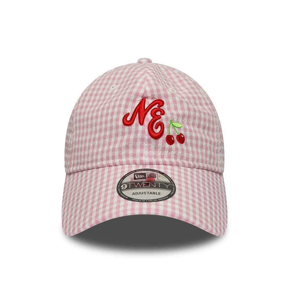 New Era Gingham Bowback Pastel Pink 9TWENTY Adjustable Cap, front view showing raised red NE embroidery with cherries on the front panel, pastel pink gingham pattern, and a 9TWENTY size sticker on the curved visor.