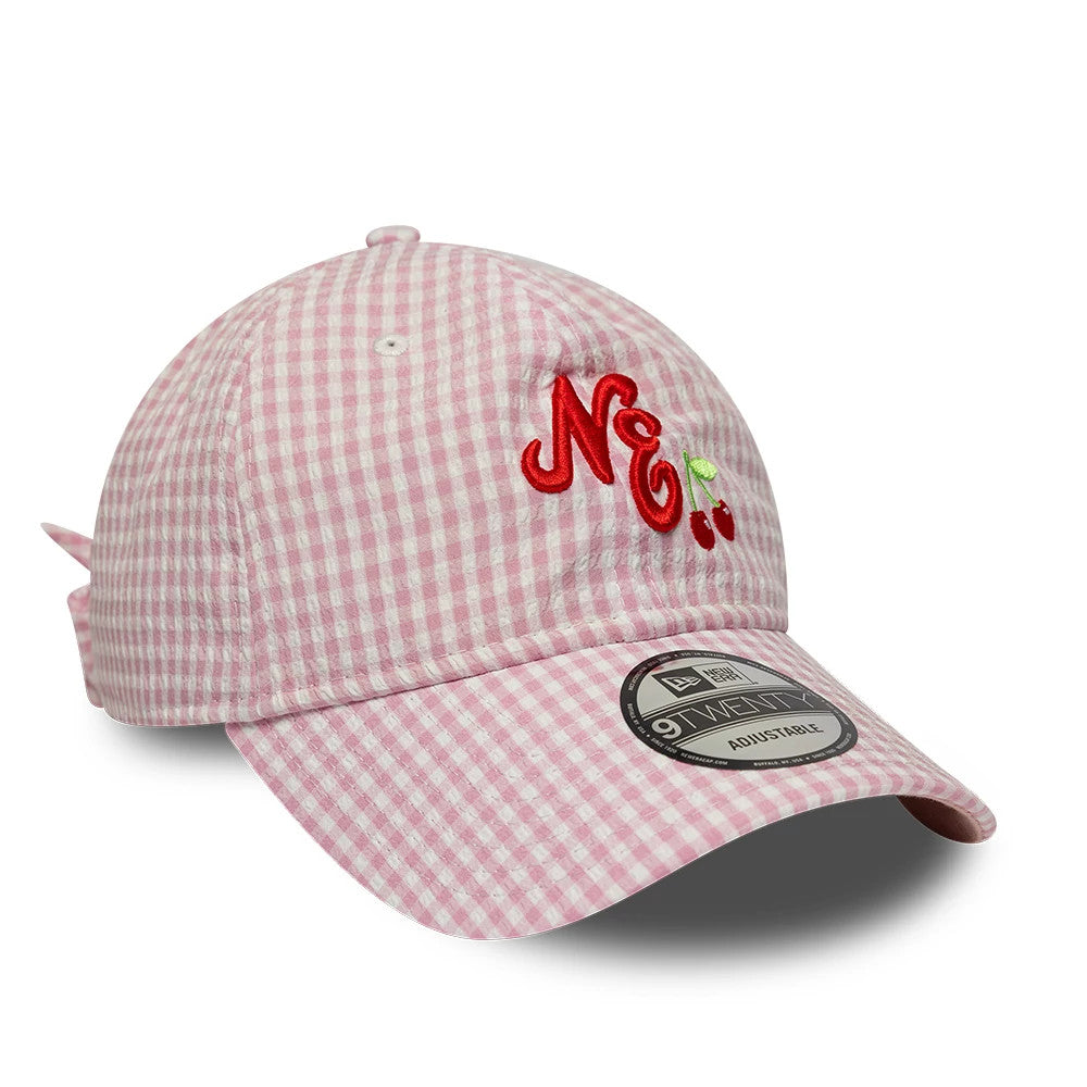 New Era Gingham Bowback Pastel Pink 9TWENTY Adjustable Cap, three-quarter view showing a red NE logo with embroidered cherries on the front panel, a curved pastel pink gingham visor and a 9TWENTY size sticker on the right side.