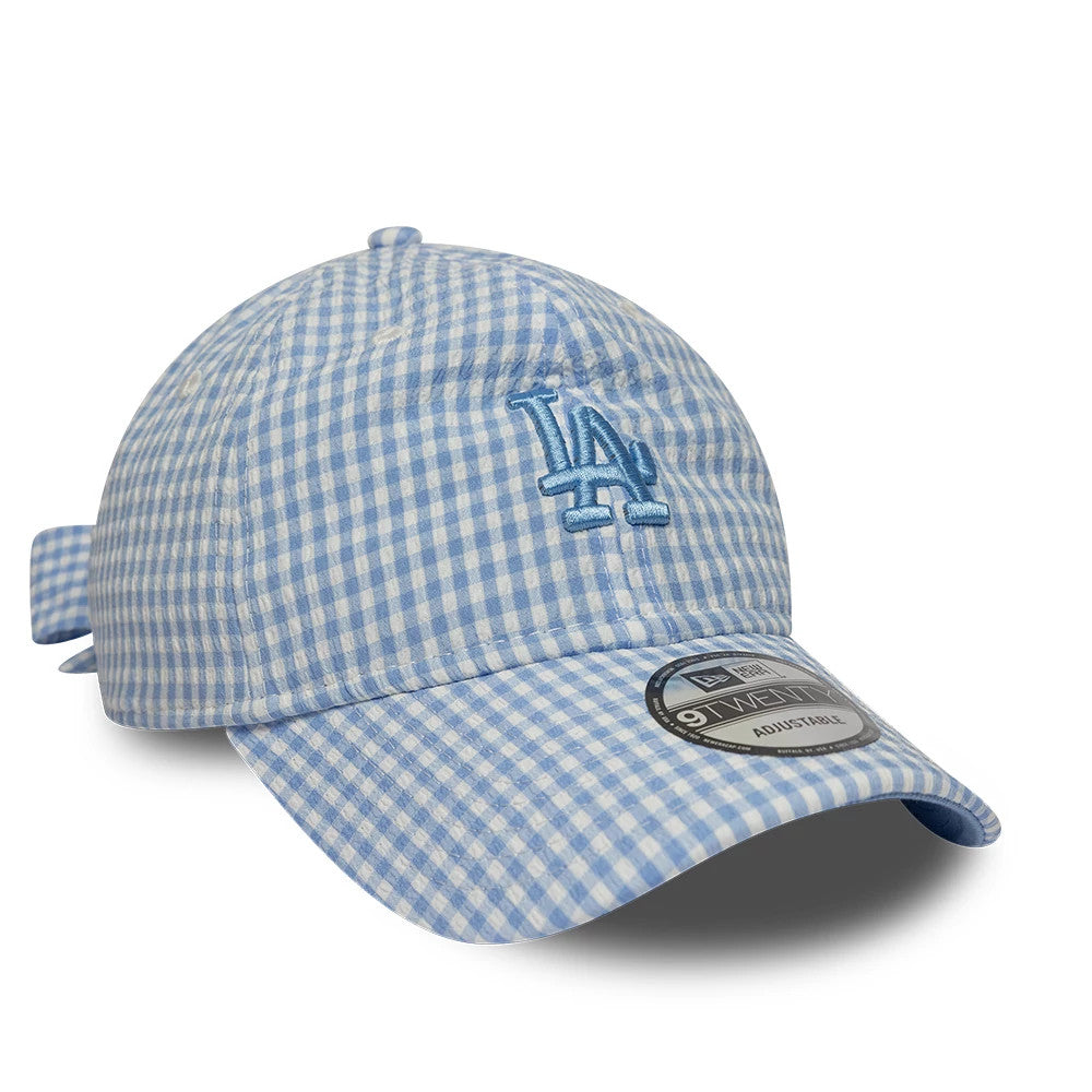 LA Dodgers MLB Gingham Bowback Pastel Blue New Era 9TWENTY Adjustable Cap, three-quarter view showing the blue LA logo embroidered on the front panel, light blue and white gingham pattern, and curved visor with the 9TWENTY size sticker.