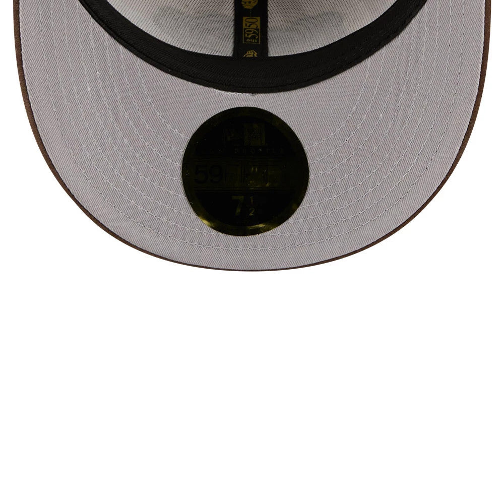 New Era 59FIFTY Day Open Beige Low Profile 59FIFTY Fitted Cap, inside view showing a black sweatband, gold taping with New Era logos, and a gold 59FIFTY size sticker on a light beige undervisor.