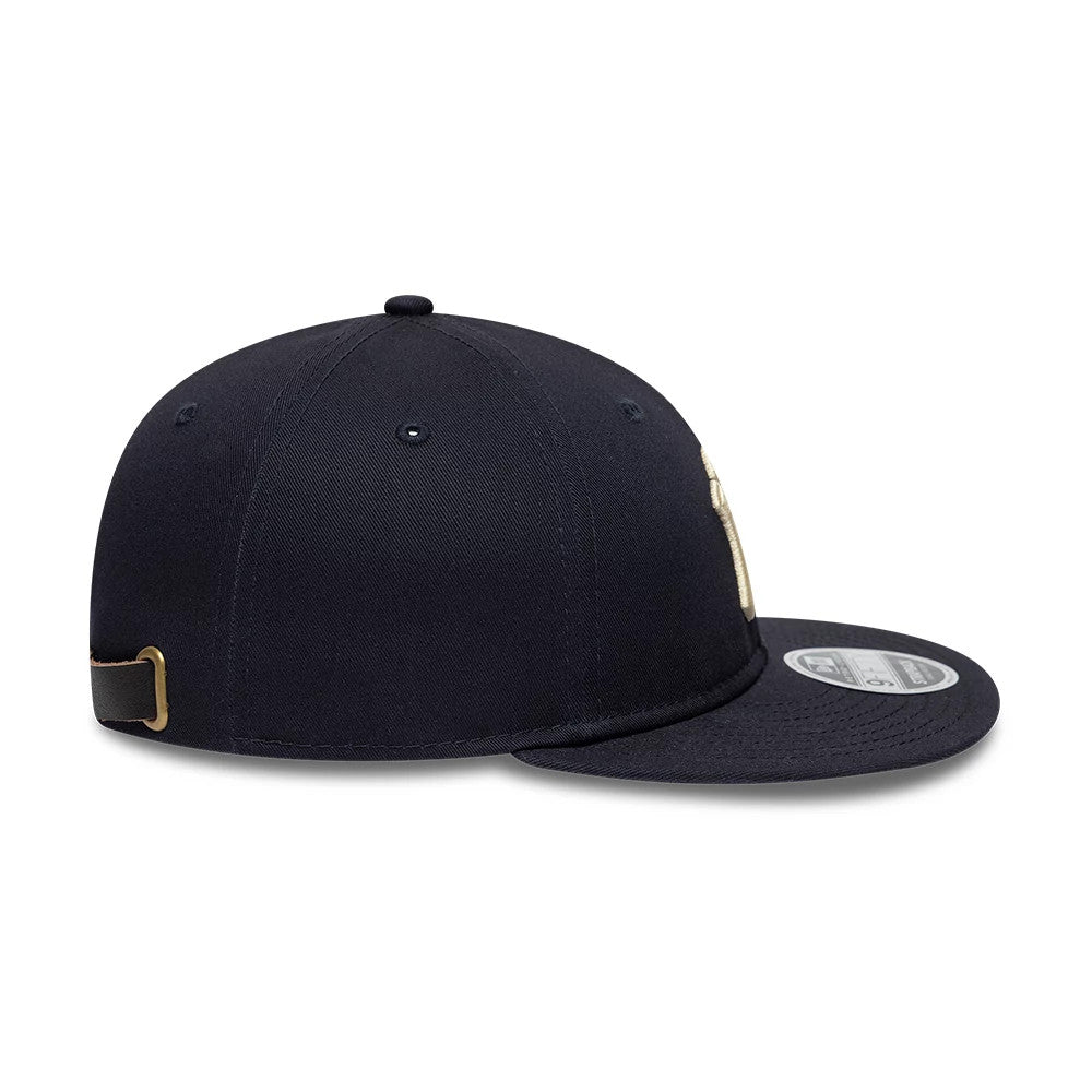 New York Yankees MLB Navy Retro Crown New Era 9FIFTY Adjustable Cap, side view showing the navy structured crown with embroidered eyelets, a curved visor with a silver 9FIFTY size sticker, and an adjustable strap at the back with brass buckle detail.