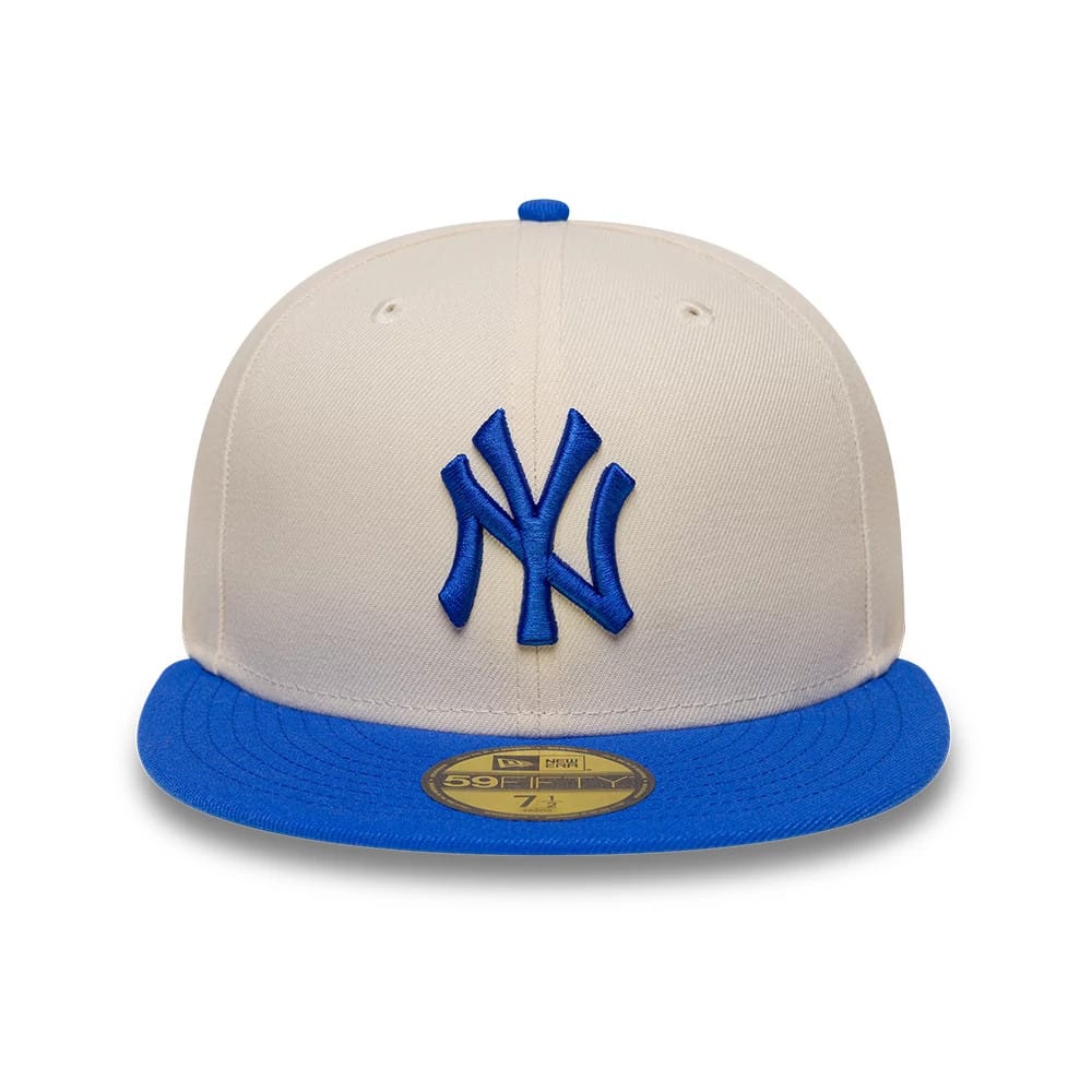 New York Yankees MLB League Essential Cream & Blue New Era 59FIFTY Fitted Cap, front view showing the raised blue NY logo embroidered on the cream front panels, with a blue flat visor and a gold 59FIFTY size sticker on the visor.