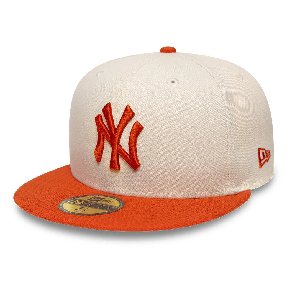 New York Yankees MLB League Essential Cream & Orange New Era 59FIFTY Fitted Cap, front three-quarter view showing an orange raised embroidered NY logo on the cream front panel, an orange visor with a gold 59FIFTY size sticker.