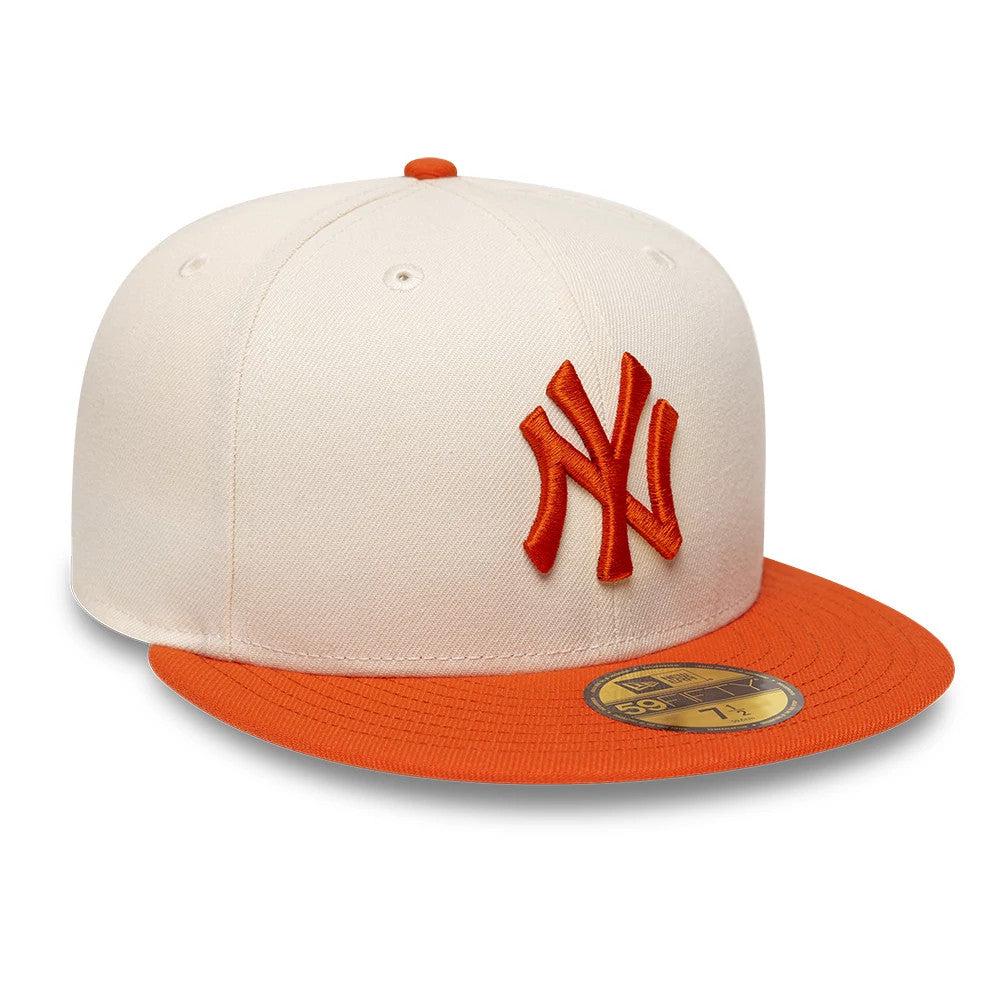 New York Yankees MLB League Essential Cream & Orange New Era 59FIFTY Fitted Cap, three-quarter view showing a raised orange NY logo embroidered on the front panel, an orange flat visor, and a gold 59FIFTY size sticker underneath.