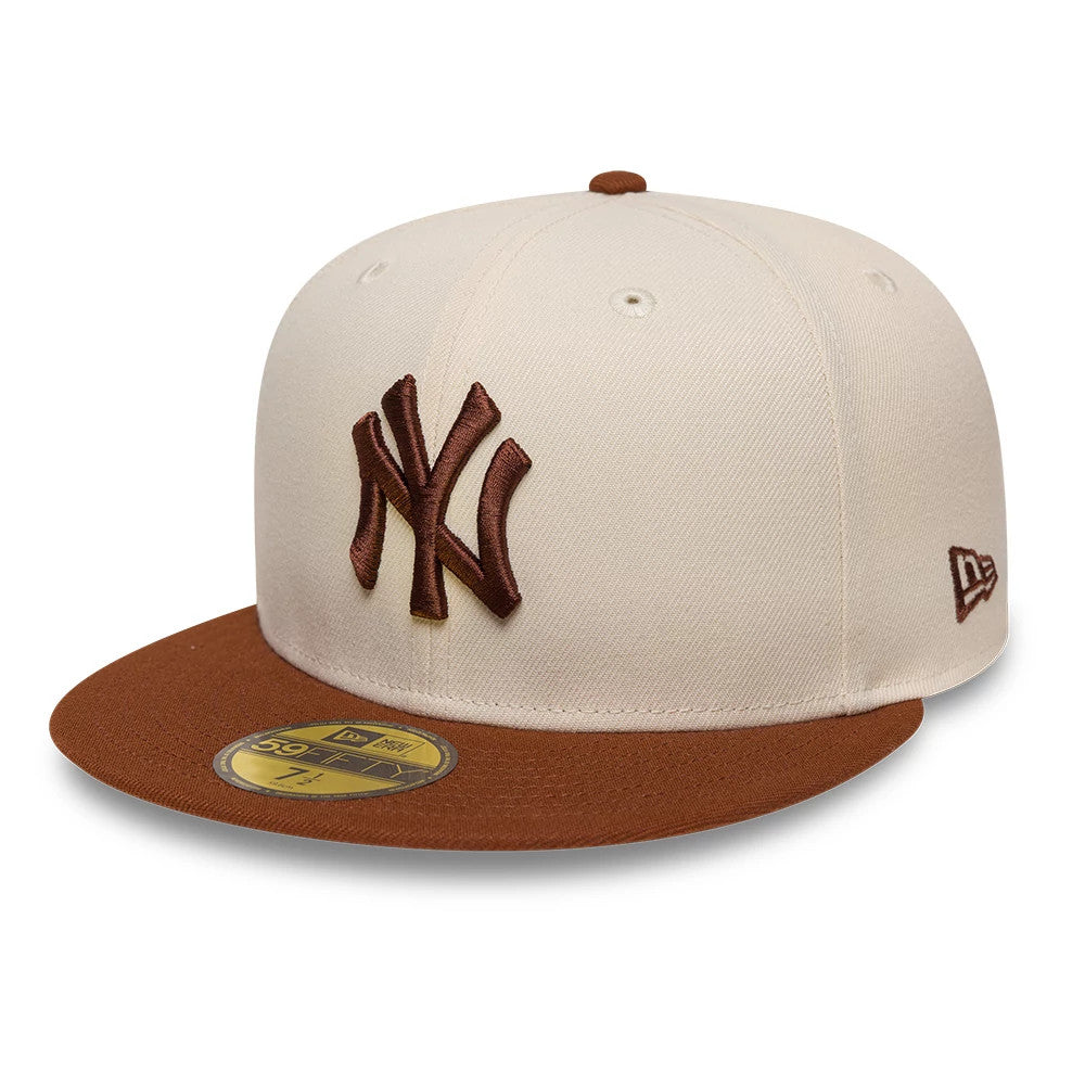 New York Yankees MLB League Essential Cream & Brown New Era 59FIFTY Fitted Cap, three-quarter view showing a raised brown embroidered NY logo on the cream front panel, brown flat visor with a gold 59FIFTY size sticker.