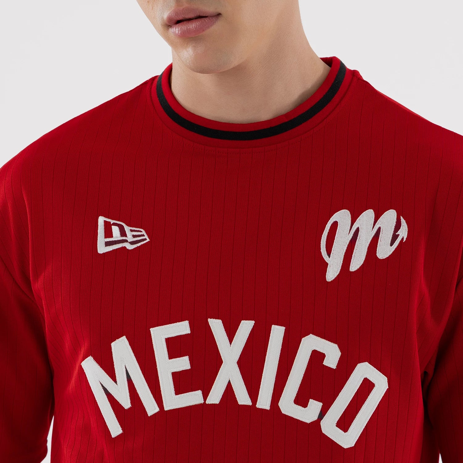 The model is wearing this LMB Mexico Diablos Oversized T-Shirt in red. 4