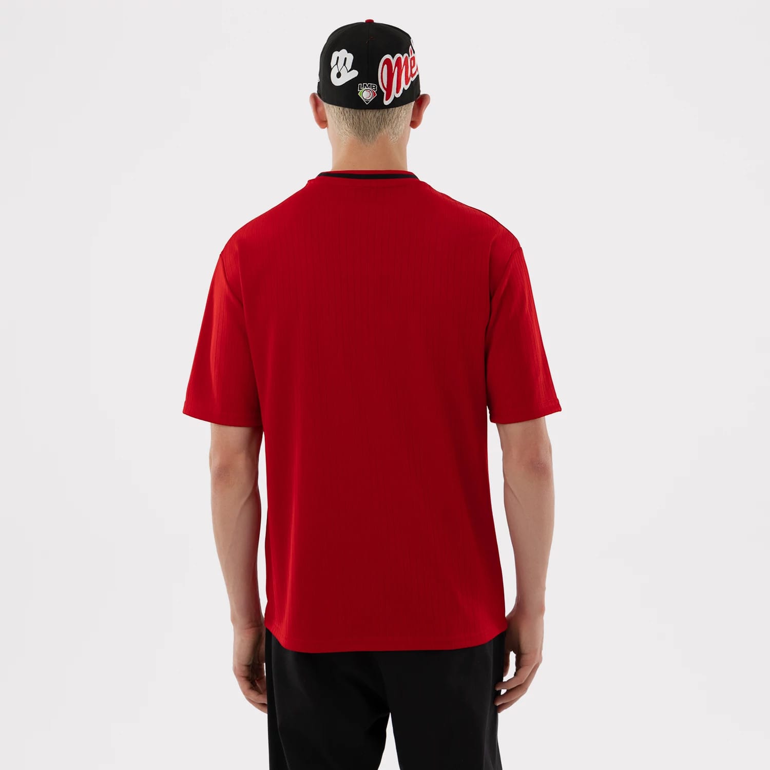 The model is wearing this LMB Mexico Diablos Oversized T-Shirt in red. 2