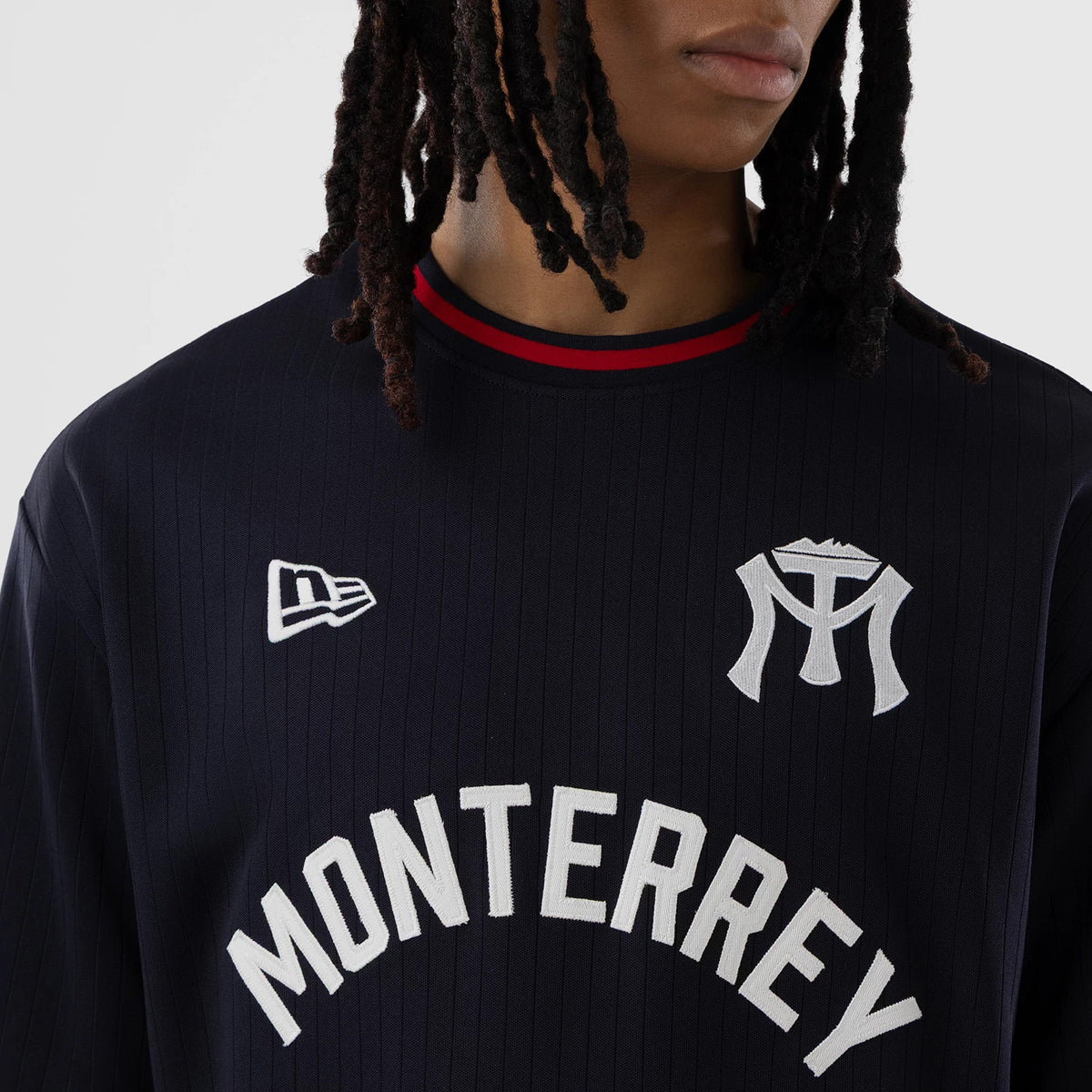 New Era Sultanes De Monterrey LMB Navy Oversized T-Shirt, front view showing embroidered Monterrey lettering across the chest, a prominent team logo on the upper right, and an embroidered New Era flag logo on the left chest near the shoulder.