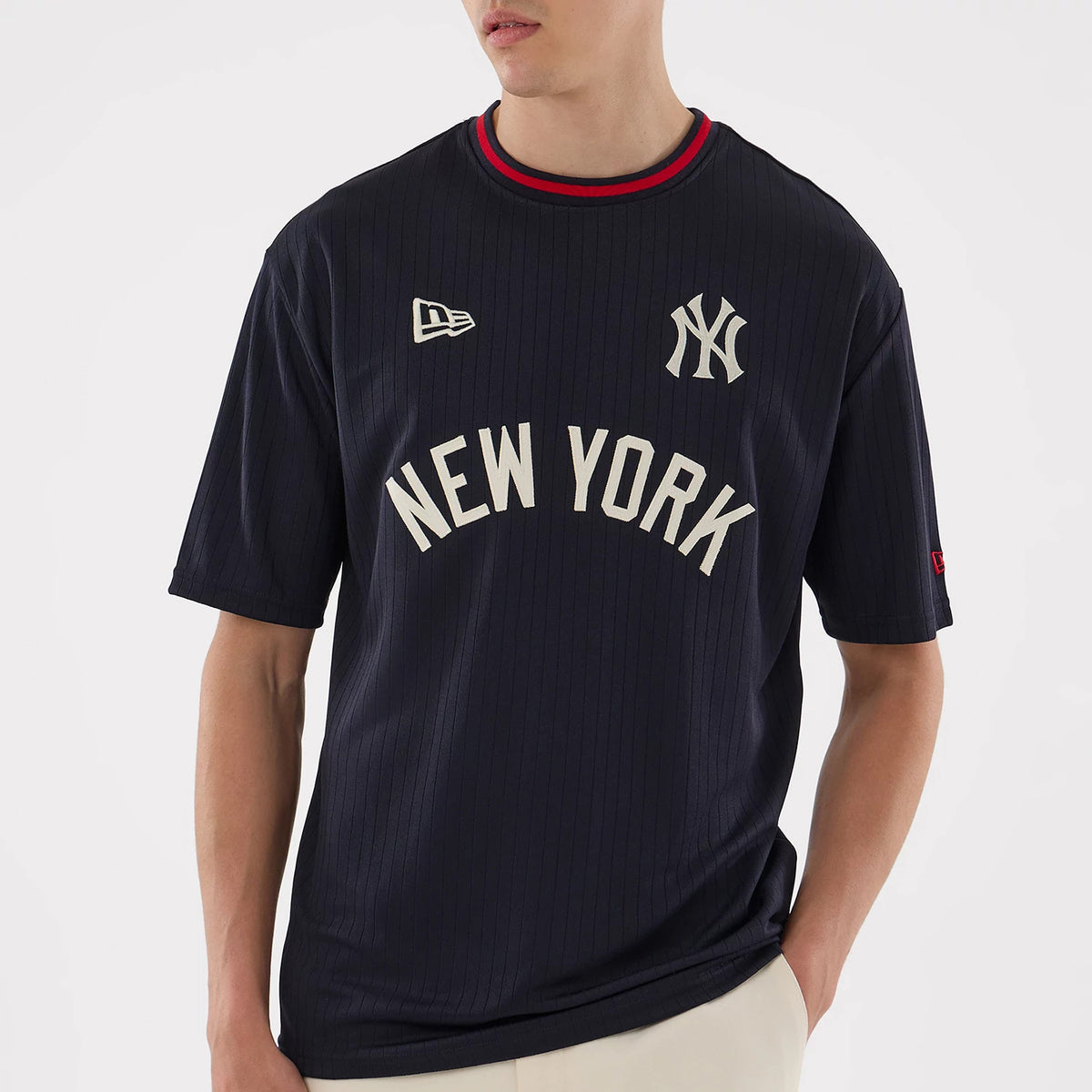 New Era New York Yankees MLB Navy Oversized T-Shirt, front view on-model showing the printed New York Yankees logo on the left chest, New York lettering across the torso, an embroidered New Era logo on the right chest and red on the collar.