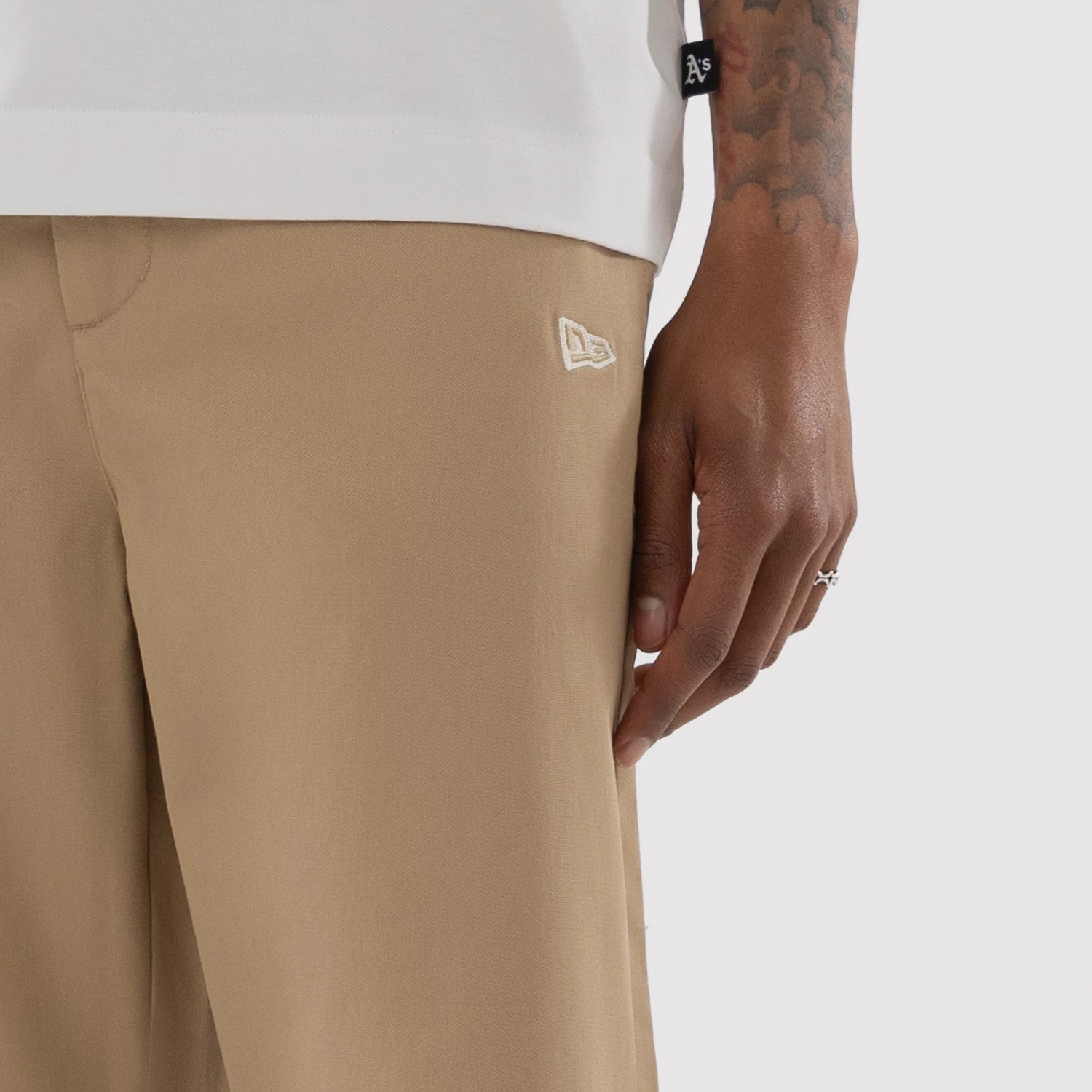 The model is wearing this MLB Athletics Chino Trousers in light beige. 4